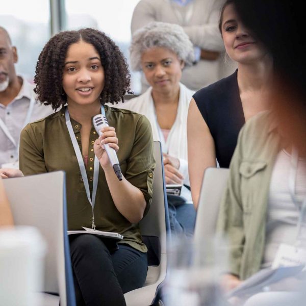 At the women's health expo, a student asks an unidentified speaker a question.